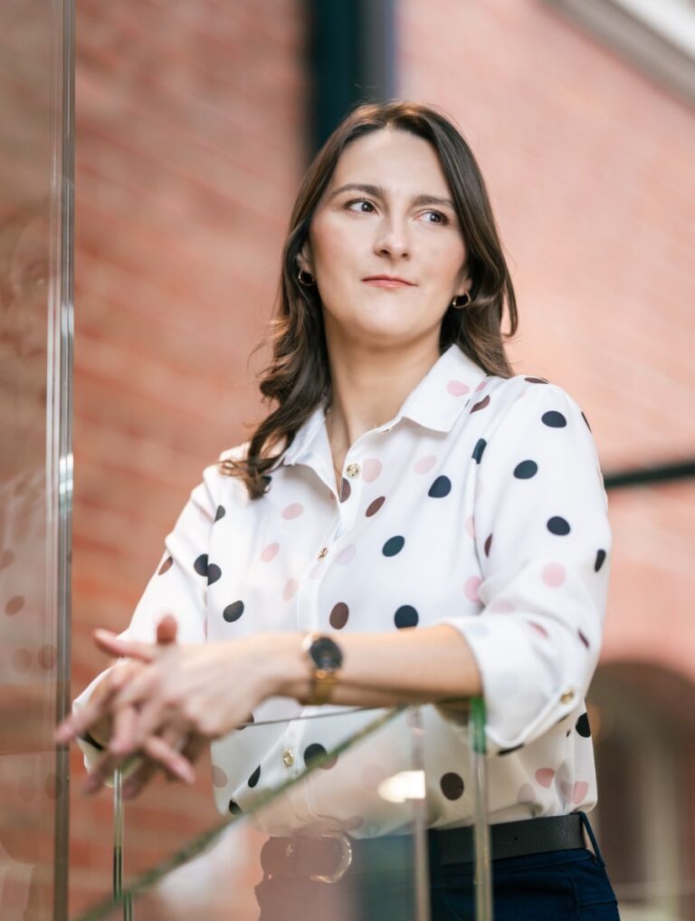 Dorothy Walas from IVF Media standing indoors in a polka dot shirt.